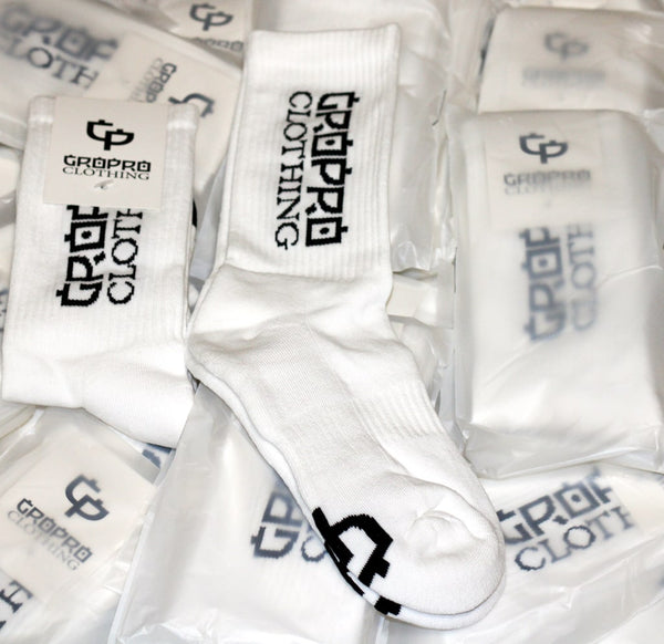 gropro clothing athletic crew sock, white with black logos to sides & sole. open pack, folded and packaged & sealed in a compostable bag. 