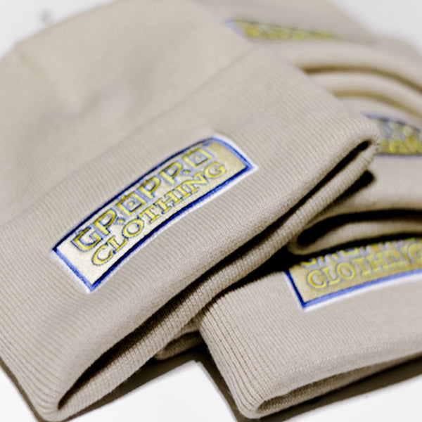 Sand coloured beanie hats, GROPRO Clothing. Growth & Progression Clothing, apparel, Headwear. Gold, White & Blue Embroidery.